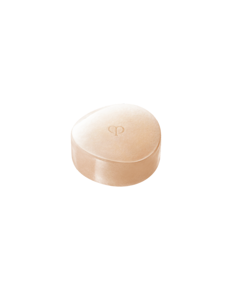 Photo of an elegant, coral pink SYNACTIF SOAP. The center is embossed with a logo, and the smooth surface conveys a sense of luxury.