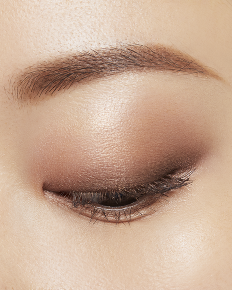 Photo of a medium skin tone model wearing EYE COLOR QUAD in 5-Coral Reeft on the eyes.