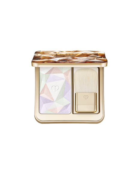 Photo of  &ldquo;THE LUMINIZING FACE ENHANCER,&rdquo; a face powder set that includes a highlighter powder designed with geometric patterns in lavender, light green, and beige pink, along with a gold brush. Shade: 17-Celestial Sparks.