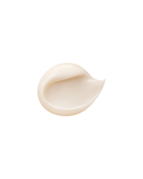 A photo of a glossy, smooth, milky-white cream texture.