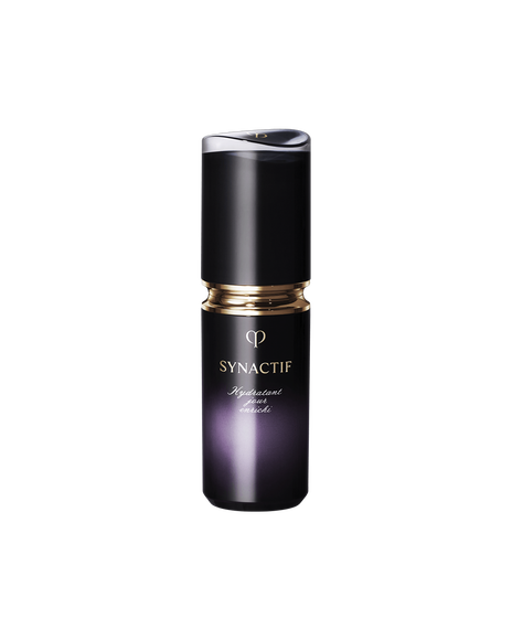 Photo of the Cl&eacute; de Peau Beaut&eacute; SYNACTIF MOISTURIZER ENRICHED. It is presented in a compact cylindrical bottle with a black-to-purple gradient. There is a gold accent between the cap and the body, and the 'SYNACTIF' logo is elegantly displayed on the front. SIZE : 20g