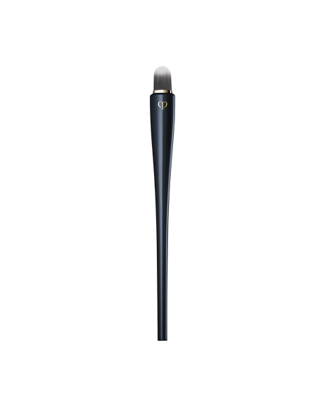 Photo of &ldquo;CONCEALER BRUSH&rdquo; featuring a sleek, blue-black handle with a gold brand logo, and a compact, rounded tip.