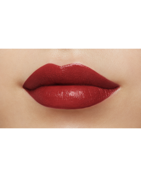 Photo of a medium skin tone model  wearing "LIPSTICK MATTE" in High Achieve on the lips.