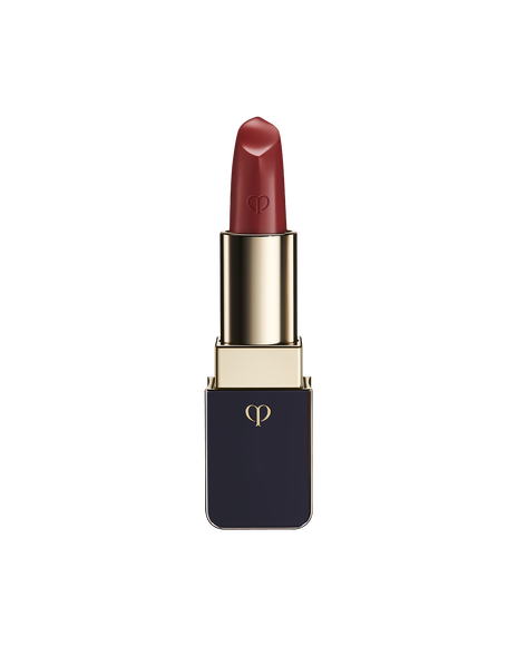 Photo of "LIPSTICK MATTE" with the stick twisted up. The tip is engraved with the brand logo, and the body features a combination of blue-black and gold sides. SHADE: Orange Cosmos.