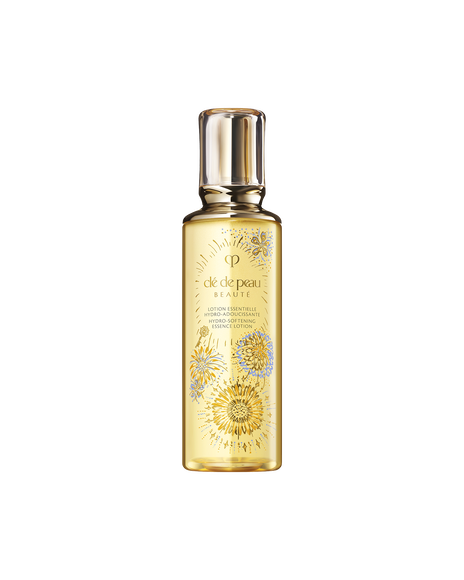 Photo of the 26 SS Gift Collection limited-edition HYDRO-SOFTENING ESSENCE LOTION. The golden-toned bottle features the Radiance Fireworks design with flowers blooming like fireworks and a key motif. 