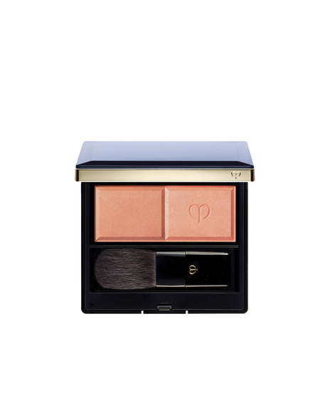 Photo of the "POWDER BLUSH DUO (REFILL)" set in a square compact with a navy lid and gold trim, containing two blush shades and a brush. The left side holds the matte powder, and the right side holds the pearly powder embossed with the logo.  Shade: 103.