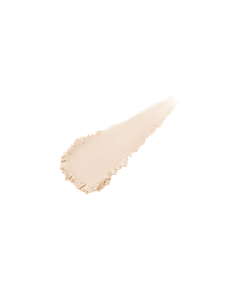 Photo of the texture of TRANSLUCENT LOOSE POWDER. A small swatch of the fine, silky, shimmery powder appears on a light surface to highlight its delicate finish.  Shade: Light Medium