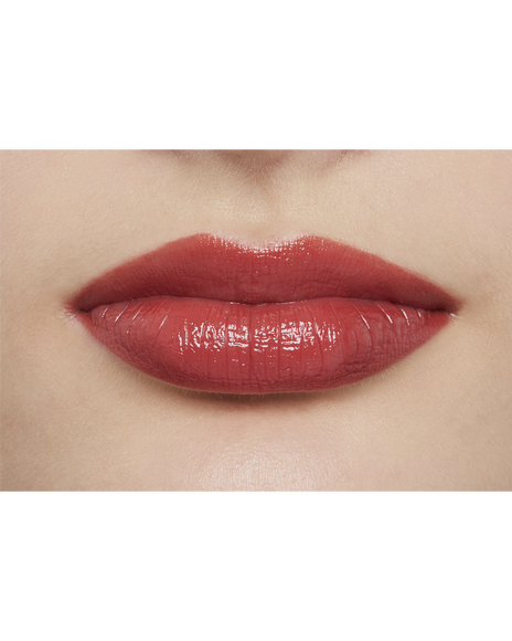 Photo of a light skin tone model  wearing  "LIPSTICK" in Whispering Rosewood on the lips.