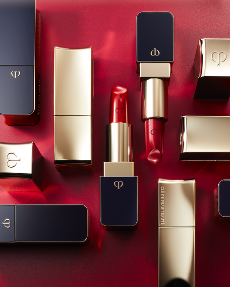 Photo of multiple "LIPSTICK" products placed on a red background.