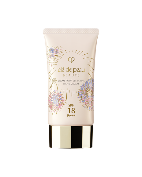 Photo of the 26 SS Gift Collection limited-edition HAND CREAM. The light pink tube features the Radiance Fireworks design with illustrations of flowers blooming like fireworks and a key motif. 