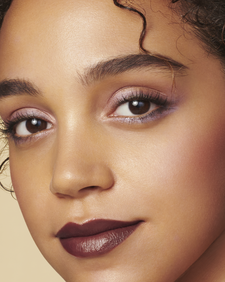 Photo of THE LUMINIZING FACE ENHANCER Shade: 17-Celestial Sparks applied to the cheeks of a model with deep skin tone.