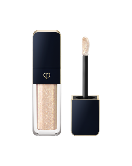 Photo of "CREAM ROUGE SPARKLES", with a blue-black cap engraved with the brand logo and a transparent body. The cap includes an applicator with a precision tip. SHADE: 302.