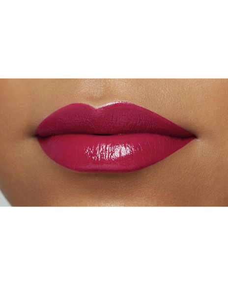 Photo of the lips of a model with a deep skin tone wearing "LIPSTICK" in the shade Raspberry Radiance.