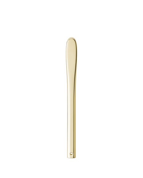 Photo of a simple yet elegant gold-colored spatula for applying cream.