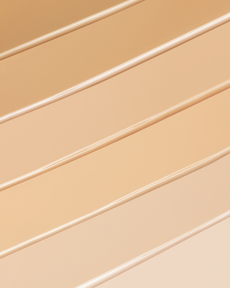 Photo showing multiple layers of smoothly spread foundation in different shades.