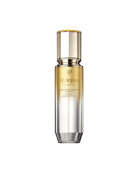 Photo of a "FIRMING SERUM SUPREME bottle with a gradient design transitioning from gold at the top to silver at the bottom. SIZE : 40ml