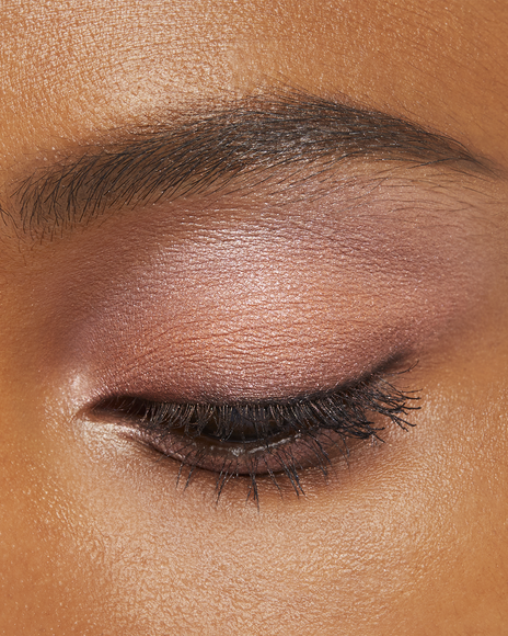 Photo of a deep skin tone model wearing EYE COLOR QUAD in 8-Warm Ocean Sunsett on the eyes.