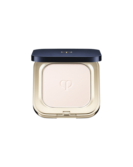 Photo of "REFINING PRESSED POWDER", set in a square compact featuring a blue-black lid with gold trim. The powder features the brand logo embossed at the center.