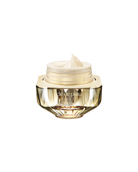 Photo of Cl&eacute; de Peau Beaut&eacute;&rsquo;s high-performance cream &ldquo;La Cr&egrave;me,&rdquo; housed in a jewel-cut, translucent gold container. The lid is open, revealing the smooth cream inside.