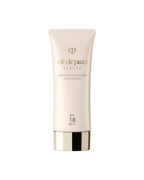 Photo of a pale pink tube of "HAND CREAM". The cap features a faceted gold design, and the front displays the gold brand logo along with SPF18 PA++ labeling.