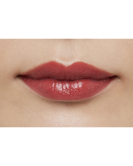 Photo of a medium skin tone model  wearing "LIPSTICK" in Whispering Rosewood on the lips.