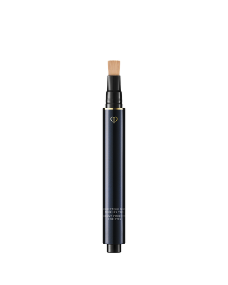 Photo of "RADIANT CORRECTOR FOR EYES", a sleek, blue-black pen-style concealer with a built-in flat brush applicator on top. Shade: Almond.