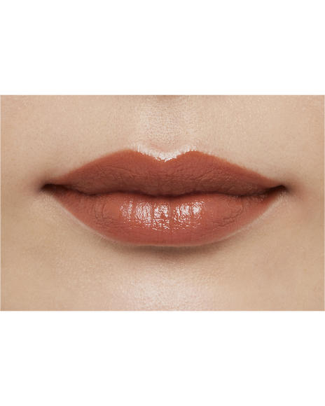Photo of a medium skin tone model  wearing "LIPSTICK" in Amberkiss Pansy on the lips.