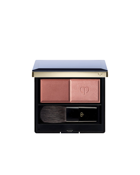 Photo of the"POWDER BLUSH DUO (Refill)"  set in a square compact with a navy lid and gold edges. The compact contains two blush shades and a brush: matte powder on the left, and pearly powder with the brand logo on the right. SHADE: 101.