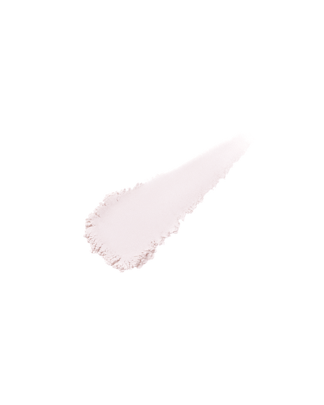 Photo of the texture of TRANSLUCENT LOOSE POWDER. A small swatch of the fine, silky, shimmery powder appears on a light surface to highlight its delicate finish. Shade: Light.