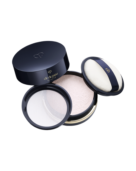 Photo of "TRANSLUCENT LOOSE POWDER". The lid of the blue-black compact is open. The brand logo is engraved on the top of the lid, and a soft white puff is attached. Shade: Light.