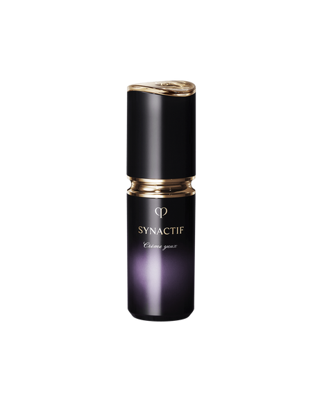 Photo of the Cl&eacute; de Peau Beaut&eacute; SYNACTIF EYE CREAM. It is housed in a compact cylindrical bottle featuring a black-to-purple gradient. A gold accent is placed between the cap and body, and the 'SYNACTIF' logo is displayed on the front.