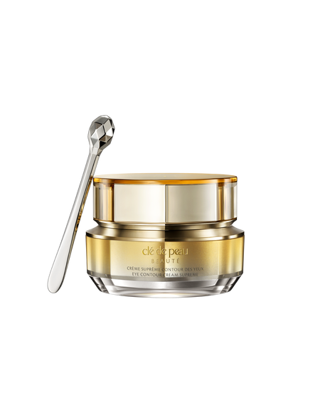 Photo of a jar of "EYE CONTOUR CREAM SUPREME" with a gold-to-silver gradient and a faceted silver spatula. SIZE: 15g