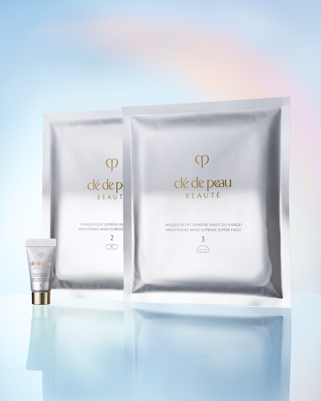 "Photo of the contents of ""BRIGHTENING MASK TREATMENT SUPREME,"" showing the sheet masks and pre-mask cleanser arranged together.  "