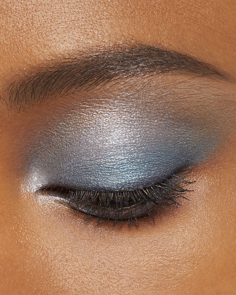 Photo of a deep skin tone model wearing EYE COLOR QUAD in 11-Azure Blue Seat on the eyes.