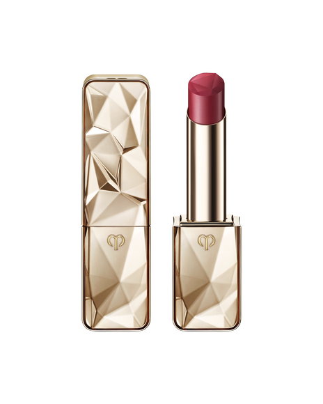 Photo of "THE PRECIOUS LIPSTICK", featuring a sparkling gold case and cap that reflects light. SHADE: Refined Amethyst.
