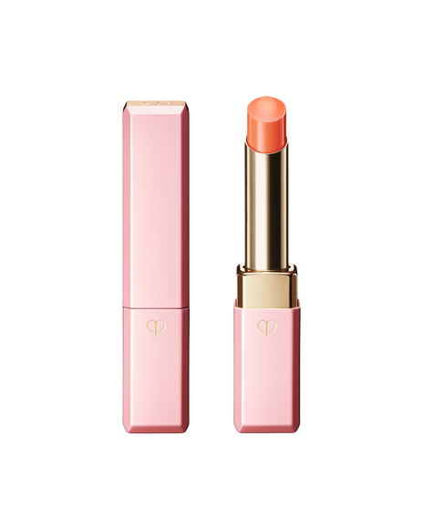 Photo of "LIP GLORIFIER" with a refined gold tube, wrapped in a bright pink cap and case. Shade: Coral.