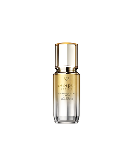 Photo of a "FIRMING SERUM SUPREME bottle with a gradient design transitioning from gold at the top to silver at the bottom. SIZE : 12ml