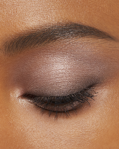 Photo of a deep skin tone model wearing EYE COLOR QUAD in 1-Sand Dunet on the eyes.