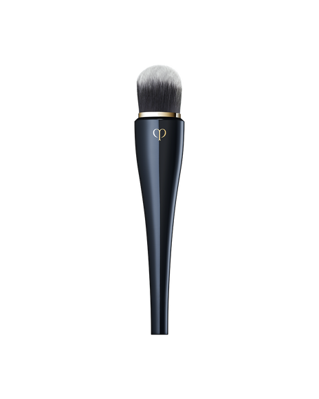 Photo of &ldquo;LIGHT COVERAGE FOUNDATION BRUSH&rdquo; featuring a sleek, blue-black handle with a gold brand logo, and soft, rounded bristles at the top designed for applying foundation.