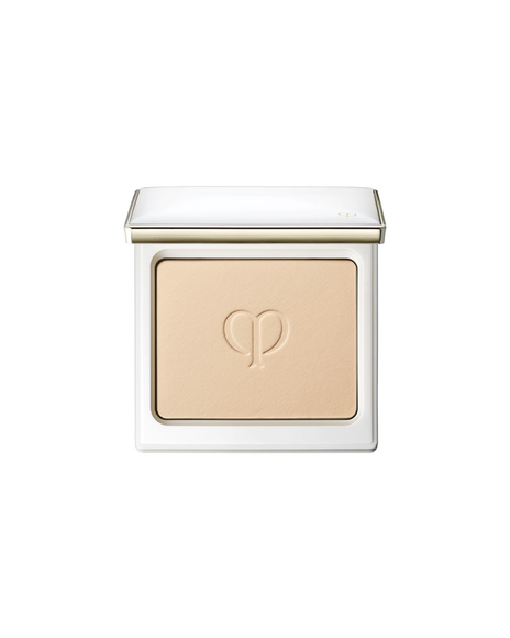 Photo of the powder foundation in a white compact case, with the brand logo embossed in the center.