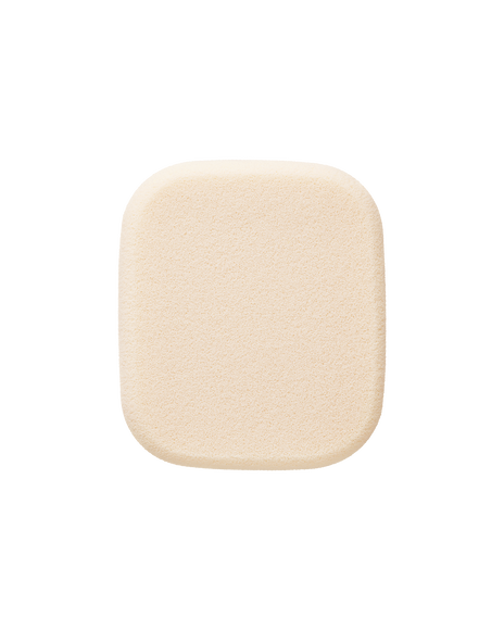 Photo of a cream-colored sponge for "RADIANT POWDER FOUNDATION". It is square-shaped with a soft texture.