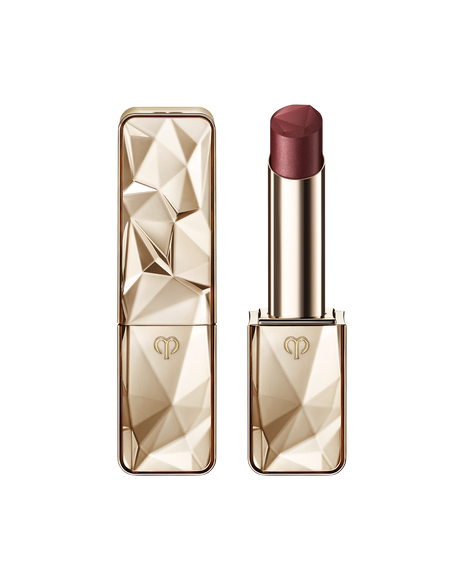 Photo of "THE PRECIOUS LIPSTICK", featuring a sparkling gold case and cap that reflects light. SHADE: Joyous Topaz.