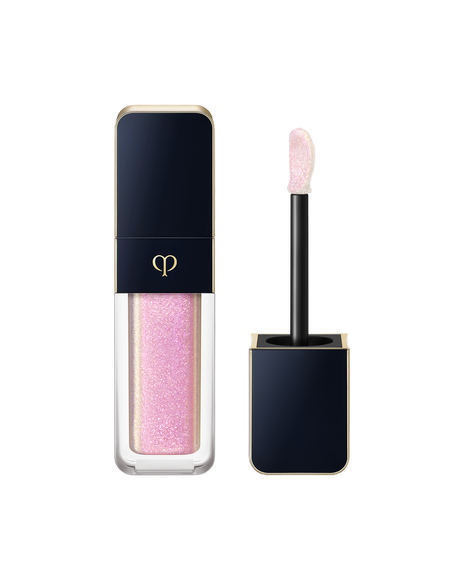 Photo of "CREAM ROUGE SPARKLES", with a blue-black cap engraved with the brand logo and a transparent body. The cap includes an applicator with a precision tip. SHADE: 303.