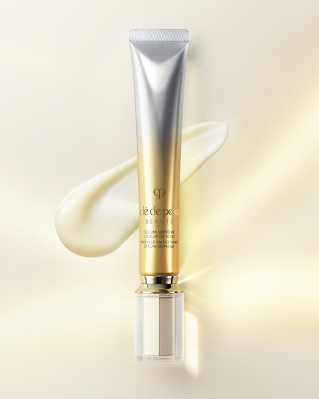 Photo of "WRINKLE SMOOTHING SERUM SUPREME" in a gold and silver gradient tube, with a serum texture in the background.