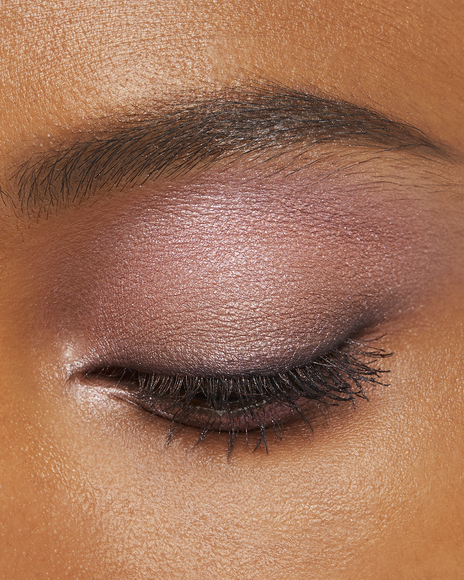 Photo of a deep skin tone model wearing EYE COLOR QUAD in 9-Pink Coral Shellst on the eyes.