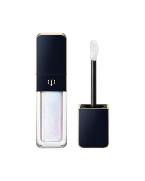 Photo of "CREAM ROUGE SPARKLES" in a clear bottle that clearly shows the color inside. The cap is blue-black with gold sides, and the brand logo is engraved on the front. The applicator has a black handle. SHADE: 301.