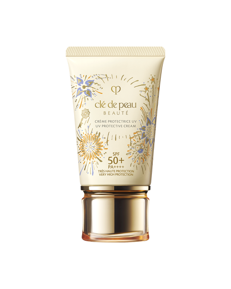 Photo of the 26 SS Gift Collection limited-edition UV PROTECTIVE CREAM. The cream-colored tube features the RADIANCE FIREWORKS design with flowers blooming like fireworks and a key motif.