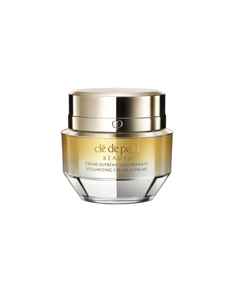A photo of a jar of VOLUMIZING CREAM SUPREME, featuring a gold and crystal-like design. SIZE: 50g