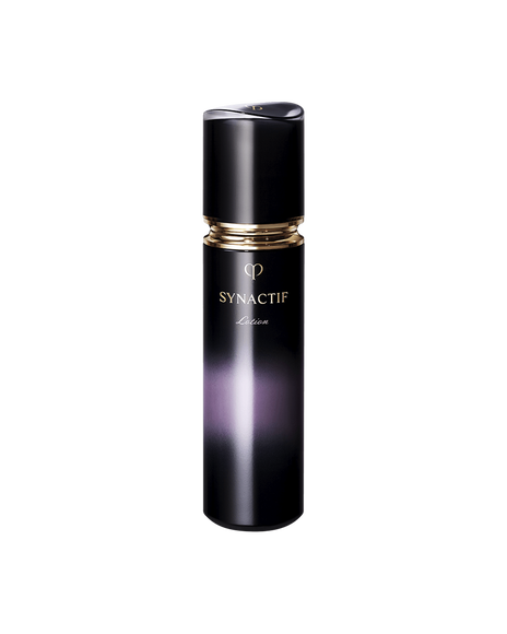 Photo of a black cylindrical SYNACTIF LOTION adorned with a shiny gold ring and gold lettering.