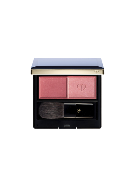 Photo of the "POWDER BLUSH DUO (REFILL)" set in a square compact with a navy lid and gold trim, containing two blush shades and a brush. The left side holds the matte powder, and the right side holds the pearly powder embossed with the logo. Shade: 102